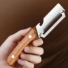 S085281a4f8da4b43a7738af3d569dfdeb.webp Stainless steel peeler with wooden handle for peeling and slicing fruits and vegetables | Durable and smooth operation
